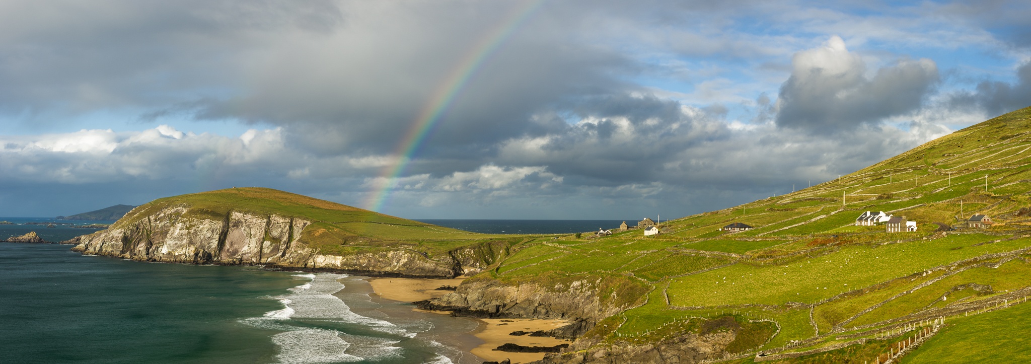 A rainbow arches over Dunmore Head near Dingle on the Dingle Peninsula, County Kerry, Ireland, International. Photograph by Marty Quinn