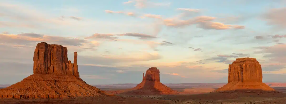 Monument Valley Mitten Shadow panorama — West Mitten shadow falling onto East Mitten at sunset