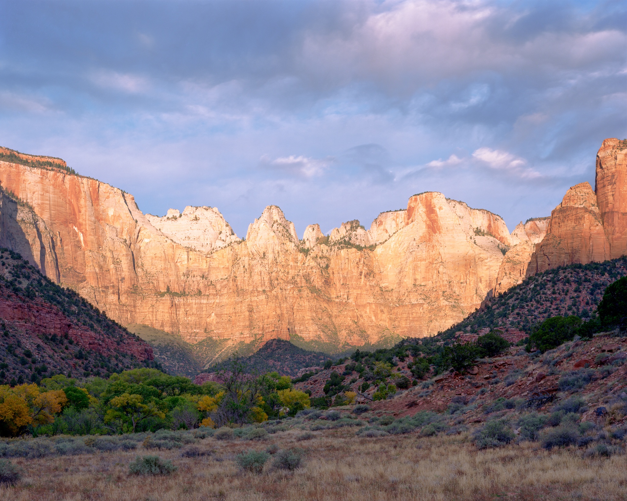 The first sun rays of the morning striking the Towers of the Virgin in Zion National Park — the extreme contrast between the lit peaks and the dark valley floor made Kodak Ektar 100 the right film choice, Utah. Photograph by Marty Quinn